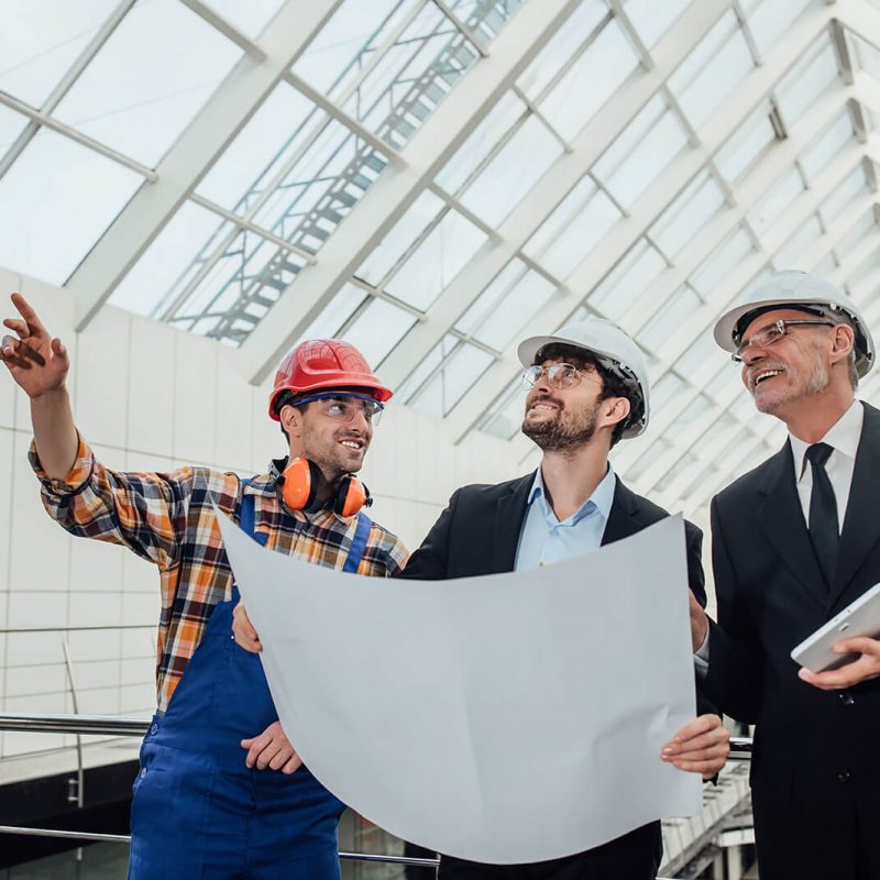 portrait-of-two-successful-architects-and-foreman-discussing-the-design-of-the-project